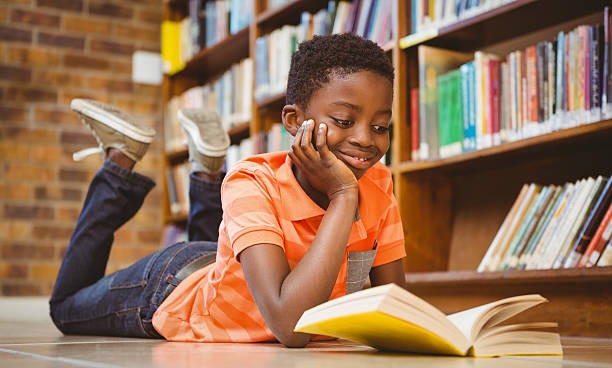 A black kid reading a book